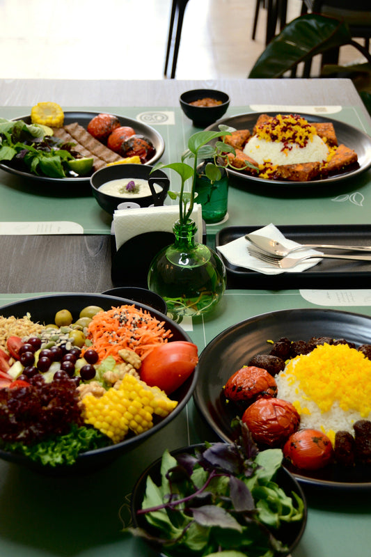 Sabzi khordan fresh herbs beside saffron rice and an Iranian meal in Karaj